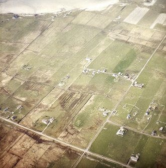 Oblique aerial view centred on the crofting township and the remains of the buildings, taken from the SE.