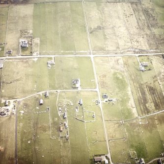 Oblique aerial view centred on the crofting township and the remains of the buildings, taken from the NNW.