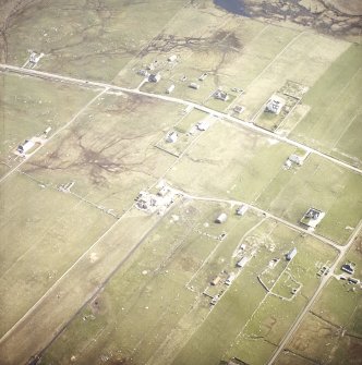 Oblique aerial view centred on the crofting township and the remains of the buildings, taken from the NW.