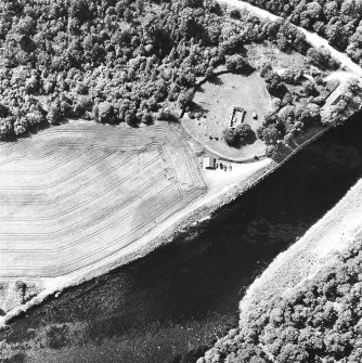 Kiltarlity, oblique aerial view, taken from the E, centred on the church and burial ground, and on the cropmarks of an enclosure.
