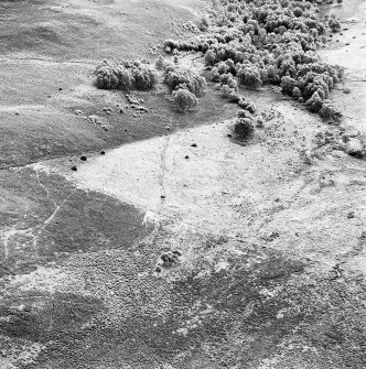Oblique aerial view of Garbeg centred on the remains of hut-circles, small cairns and a field-system, taken from the NW.