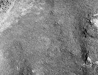 Oblique aerial view of Garbeg centred on the remains of two hut-circles in an area of small cairns and a field-system, taken from the WSW.