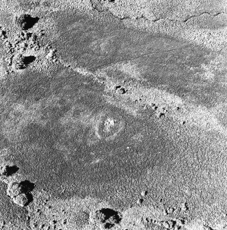 Oblique aerial view of Garbeg centred on the remains of a hut-circle in an area of hut-circles, small cairns, a field-system and rig, taken from the ESE.