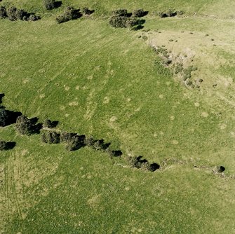 Oblique aerial view of Garbeg centred on the remains of hut-circles, small cairns and a field-system, taken from the ESE.
