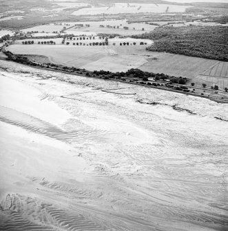 Oblique aerial view centred on the remains of the fish trap, taken from the WNW.