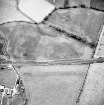 Oblique aerial view centred on the cropmarks of the pit-circles and ring-ditch, taken from the SSW.