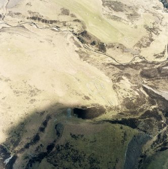 Oblique aerial view of Achad a'Chatha, taken from the W, centred on the remains of a township. Another township is visible on the opposite bank of Raitts Burn.