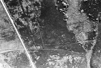 Oblique aerial view centred on the remains of the hut-circles, taken from the WNW.