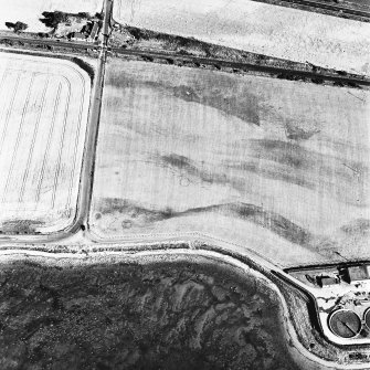 Allanfearn Station, oblique aerial view, taken from the NW, centred on the cropmarks of a barrow cemetery.