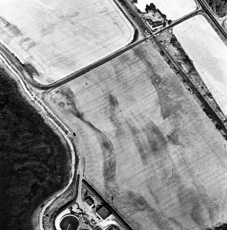 Allanfearn Station, oblique aerial view, taken from the W, centred on the cropmarks of a barrow cemetery.