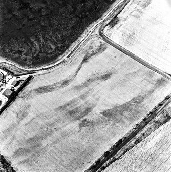 Allanfearn Station, oblique aerial view, taken from the SSW, centred on the cropmarks of a barrow cemetery.