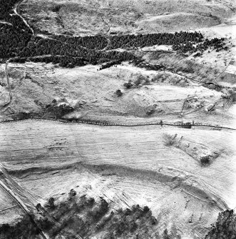 Ballourie, oblique aerial view, taken from the SE, showing the remains of a township across the photograph, and rig in the foreground.