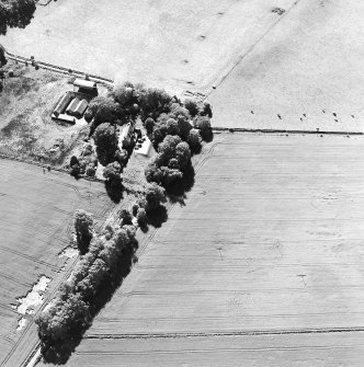 Oblique aerial view centred on the cropmarks of the unenclosed settlement with Budgate House adjacent, taken from the NE.