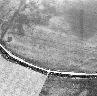 Oblique aerial view centred on the cropmarks of the palisaded enclosure, taken from the SSW.