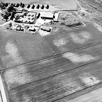 Mains of Gartan, oblique aerial view taken from the E, centred on the remains of a motte and the cropmark of a possible enclosure.  The Mains of Garten is visible in the top left hand corner of the photograph.