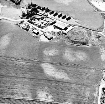 Mains of Gartan, oblique aerial view taken from the NE, centred on the remains of a motte and the cropmark of a possible enclosure.  The Mains of Garten is visible in the top centre of the photograph.