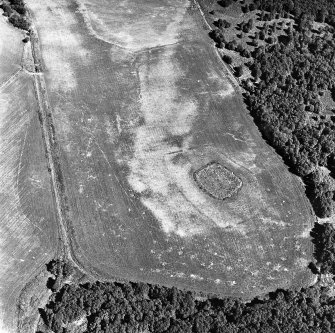 Parc-an-Caipel, Congash, oblique aerial view, taken from the WSW, centred on the remains of a chapel and burial-ground and on the cropmarks of an enclosure.