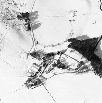 Oblique aerial view of Glenbuchat House centred on the country house, walled garden, farmsteading, cottage and the remains of a castle, taken from the SE.