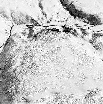Oblique aerial view of Backie Hill centred on the remains of two enclosures, taken from the NW.