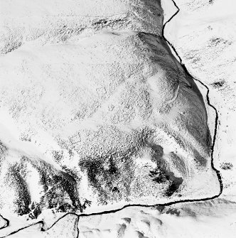 Oblique aerial view of Backie Hill centred on the remains of two enclosures, taken from the SE.