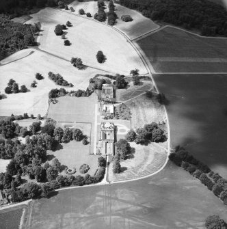 Oblique aerial view from East of Gordon Castle estate (after demolitions), including house, tower, home farm and cropmarks.