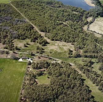 Oblique aerial view centred on the remains of the hut-circles and enclosures, taken from the ESE.