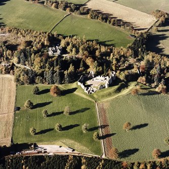 Oblique aerial view of Kildrummy castle centred on the remains of the castle with hotel adjacent, taken from the SE.