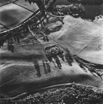 Aboyne Old Parish Church, oblique aerial view, taken from the NNE, centred on the church, with the dismantled Aboyne Extension of The Deeside Railway Line visible in the top left-hand corner of the photograph.