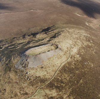 Oblique aerial view of Tap o' Noth centred on the fort, taken from the SW.