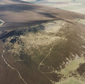 Oblique aerial view of Tap o' Noth centred on the fort, taken from the SW.