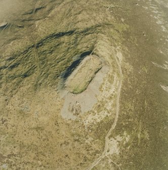 Oblique aerial view centred on the remains of the vitrified fort, taken from the WNW.