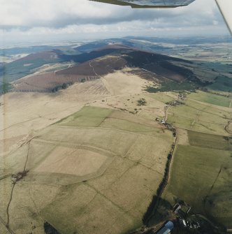 General oblique aerial view looking towards the remains of the vitrified fort, taken from the SW.