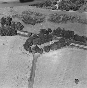 Oblique aerial view of Kennethmont centred on St Alkmund's Parish Church and burial-ground, taken from the S.