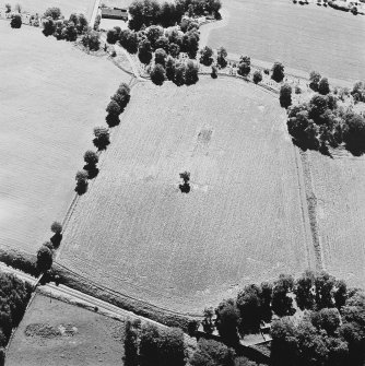 Oblique aerial view of Kirkhill centred on the cropmarks of a manse and possible ring-ditches, with a church and burial-ground adjacent, taken from the N.