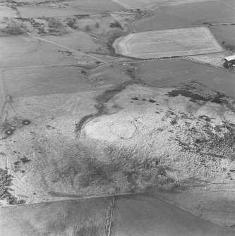 Oblique aerial view of White Hill centred on the remains of the enclosure and quarries with farmhouse adjacent, taken from the E.