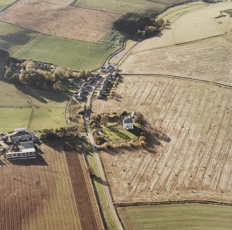 Oblique aerial view of Leslie Castle centred on the castle with farmhouse adjacent, taken from the E.