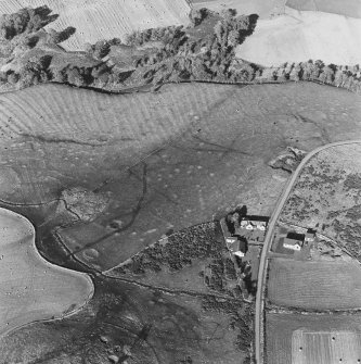 Oblique aerial view of Wardhouse Home Farm centred on the remains of hut-circles, small cairns and rig with rig, small cairns, farmstead, quarry and cottage adjacent, taken from the S.