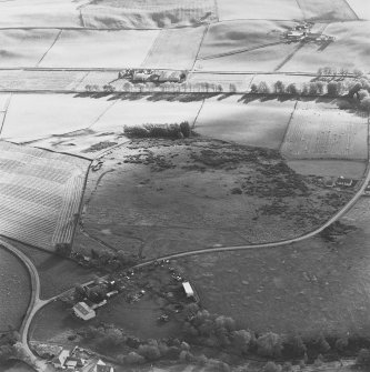 Oblique aerial view of Rosa Croft centred on the remains of cairns and field-system with small cairns and quarry adjacent, taken from the N.