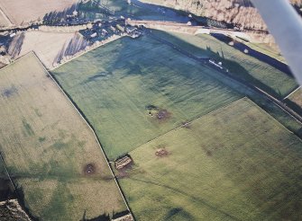 Oblique aerial view centred on the remains of the recumbent stone circle, taken from the SSW.