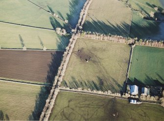 Oblique aerial view centred on the remains of the recumbent stone circle, taken from the SW.