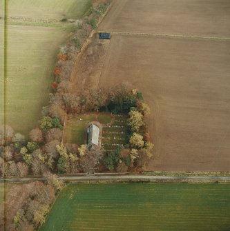 Oblique aerial view centred on the remains of the recumbent stone circle, the church and burial-ground, taken from the WSW.