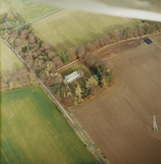 Oblique aerial view centred on the remains of the recumbent stone circle, the church and burial-ground, taken from the SW.