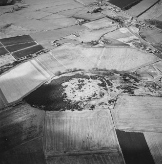 Oblique aerial view centred on the remains of the enclosure taken from the SE.