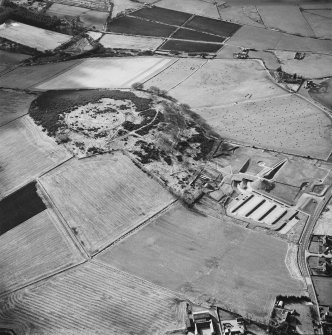 Oblique aerial view centred on the enclosure and Archaeolink visitor centre taken from the ENE.