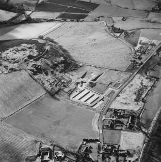 Oblique aerial view centred on the enclosure and Archaeolink visitor centre taken from the NE.