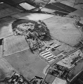 Oblique aerial view centred on the enclosure and Archaeolink visitor centre taken from the NE.