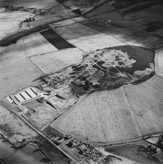 Oblique aerial view centred on the enclosure and Archaeolink visitor centre taken from the NW.