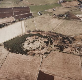 Oblique aerial view centred on the remains of the enclosure taken from the SW.