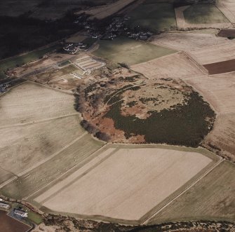 Oblique aerial view centred on the enclosure and Archaeolink visitor centre taken from the SW.