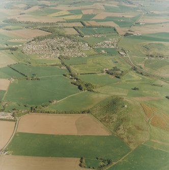 Oblique aerial view centred on the remains of the fort with village adjacent, taken from the WNW.